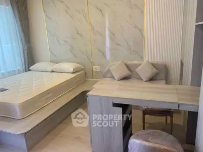 Modern bedroom with stylish decor and built-in desk, perfect for urban living.