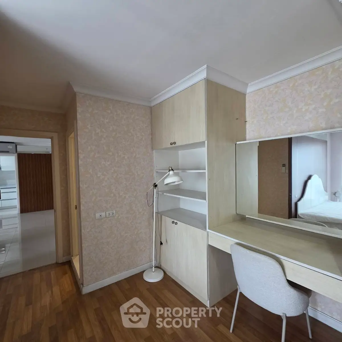 Charming bedroom with built-in desk and cozy chair, perfect for a home office setup.