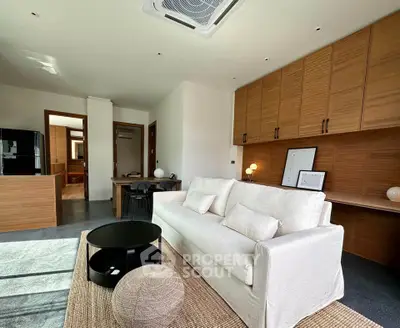 Modern living room with sleek design and cozy white sofa, perfect for relaxation.