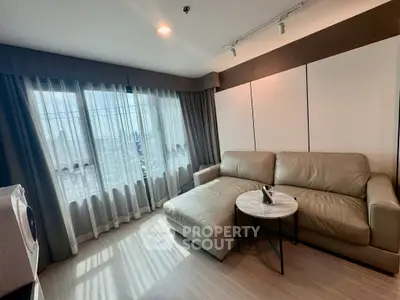 Modern living room with large window and stylish furniture