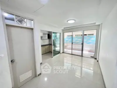 Spacious apartment interior with open layout and balcony access