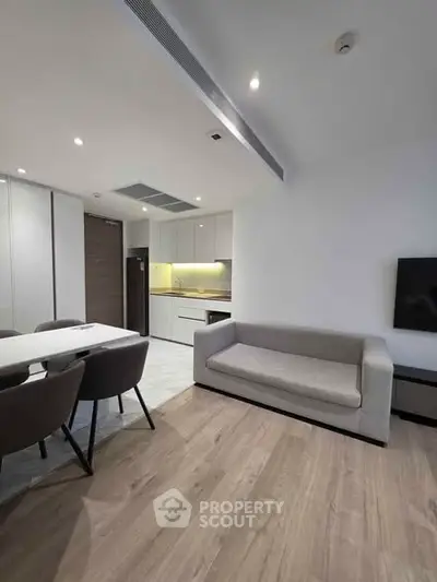 Modern open-plan living room with sleek kitchen and stylish dining area