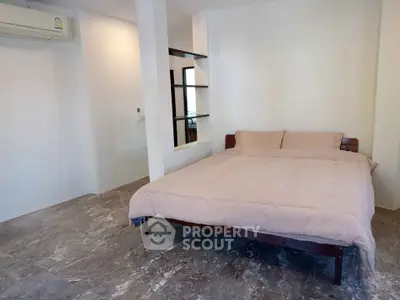Spacious bedroom with modern design and air conditioning in a stylish apartment.