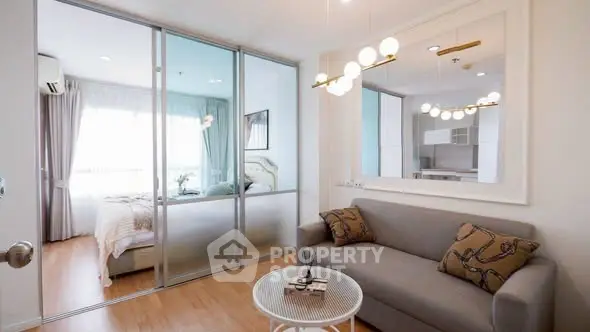 Modern living room with sliding glass doors to bedroom, stylish decor, and natural light.