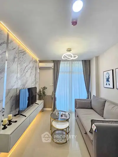 Modern living room with elegant decor, marble accent wall, and cozy seating area.