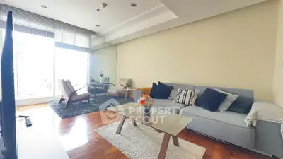 Spacious living room with modern decor and large windows offering natural light.