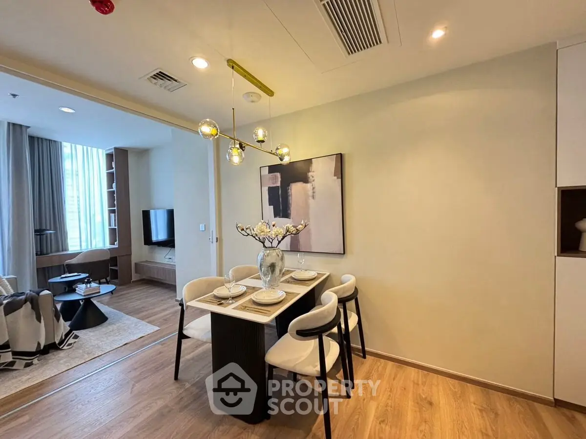 Modern dining area with elegant decor and open layout to cozy living room