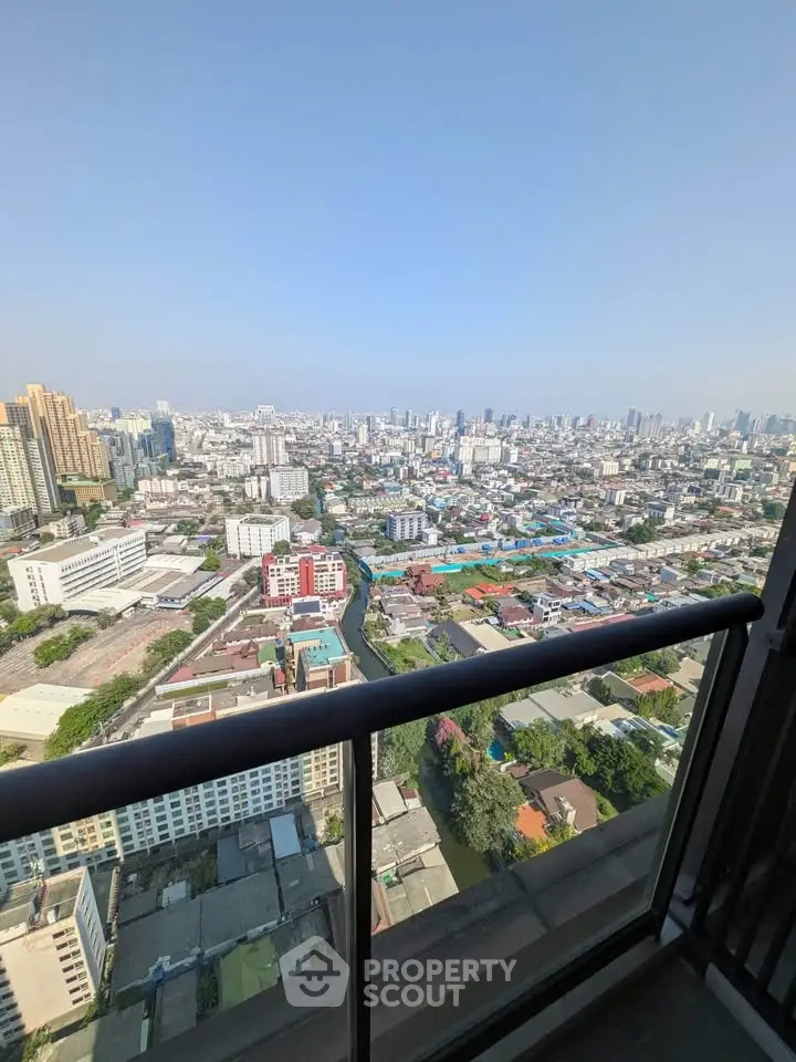 Stunning cityscape view from high-rise balcony showcasing urban skyline and vibrant city life.