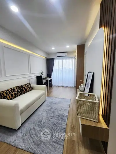 Modern living room with stylish decor and natural light, featuring a cozy sofa and elegant wooden accents.