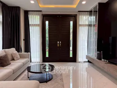 Luxurious living room with modern decor and large wooden doors