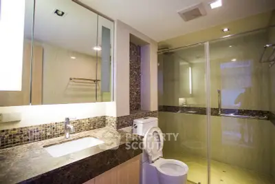 Luxurious modern bathroom with glass shower and elegant marble countertop.