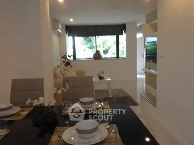 Modern open-plan living and dining area with stylish decor and natural light.