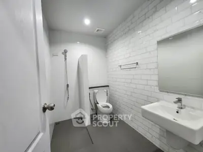 Modern bathroom with sleek white tiles and minimalist fixtures