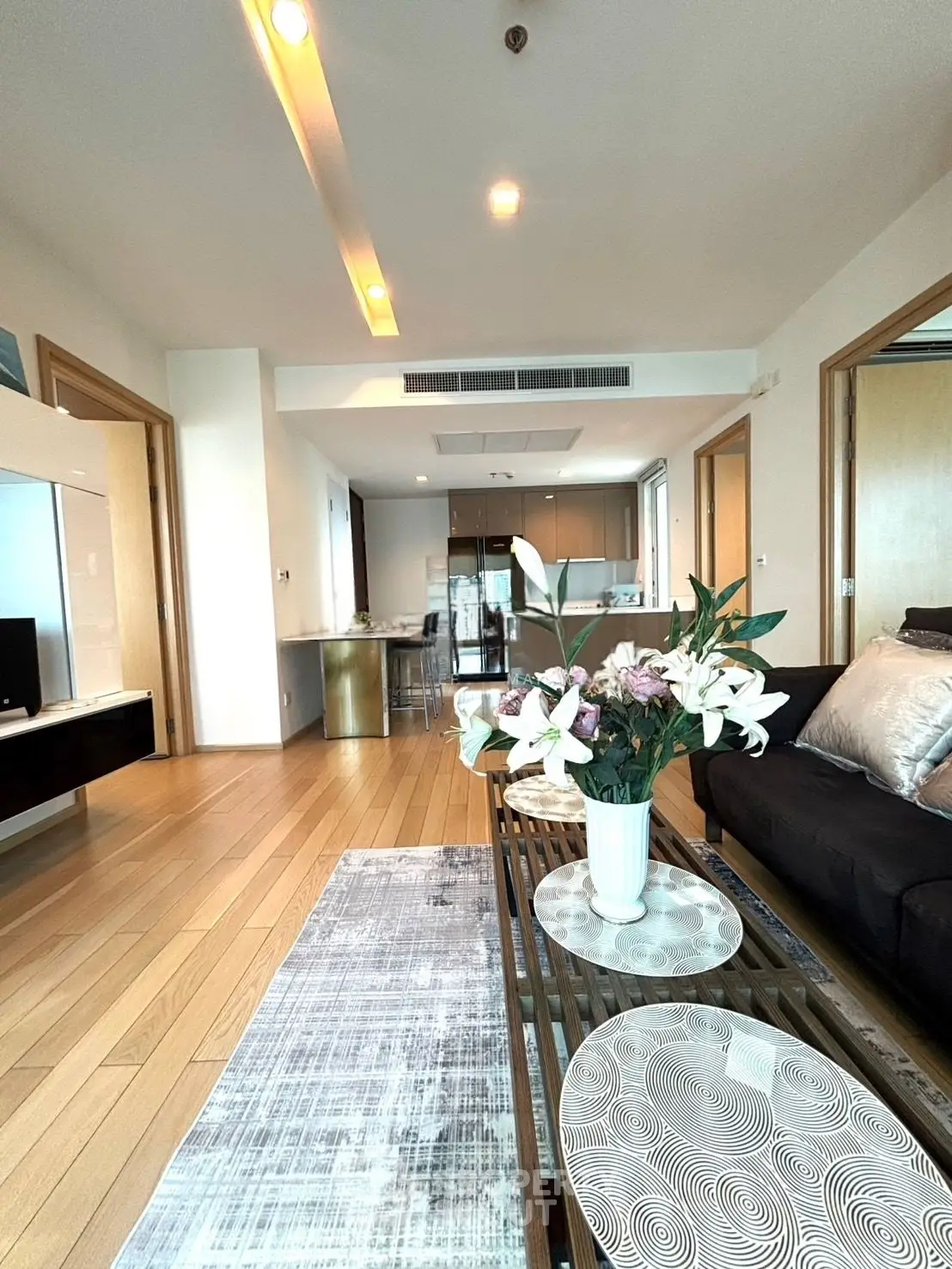 Spacious modern living room with open kitchen and elegant decor