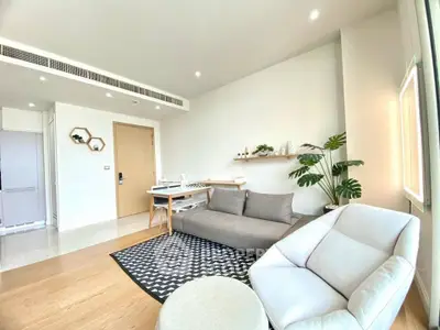 Modern living room with stylish furniture and natural light, featuring a cozy sofa and elegant decor.