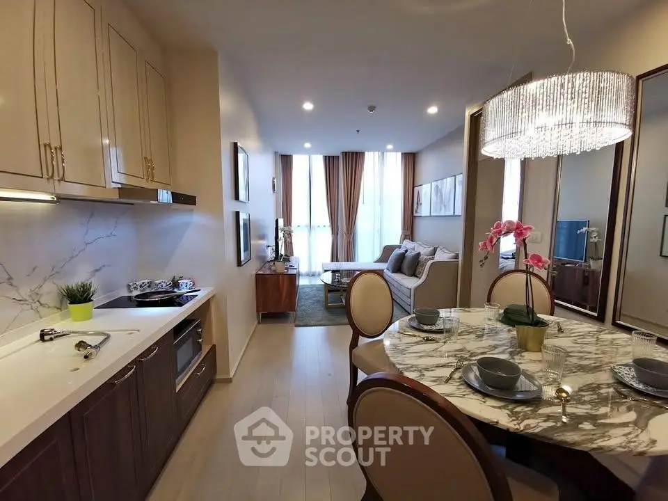 Luxurious open-plan living room and kitchen with elegant dining area and modern decor.