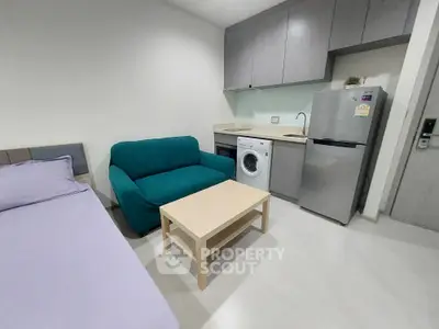 Modern studio apartment with compact kitchen and cozy living area
