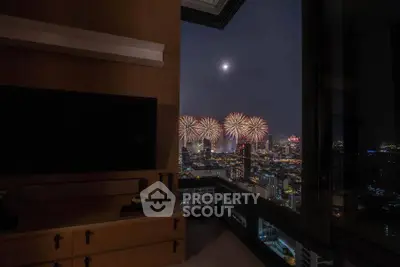 Luxurious high-rise apartment with stunning city view and fireworks display from the living room.