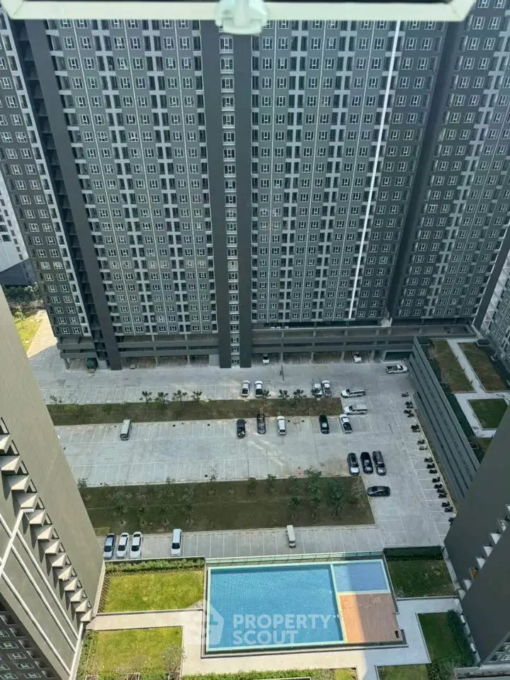 High-rise residential building with pool and parking view from above