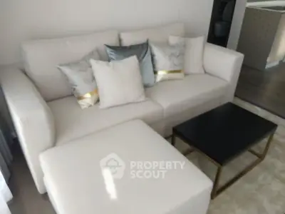 Modern living room with elegant sofa and chic decor in a stylish apartment.