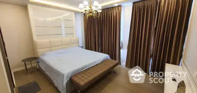 Elegant bedroom with luxurious chandelier lighting, rich brown drapery, and a large comfortable bed, showcasing a sophisticated and serene sleeping space.