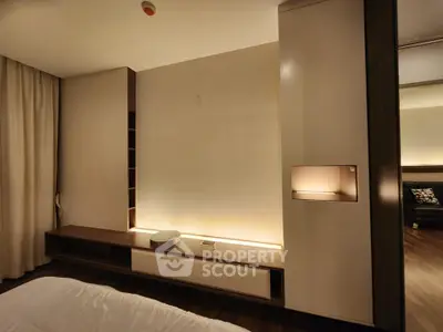 Modern bedroom with sleek built-in storage and ambient lighting