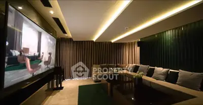 Luxurious living room with modern decor and large TV screen