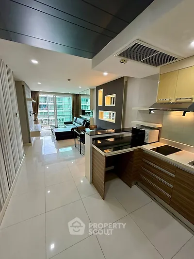 Modern open-layout kitchen and living room with sleek design and city view.