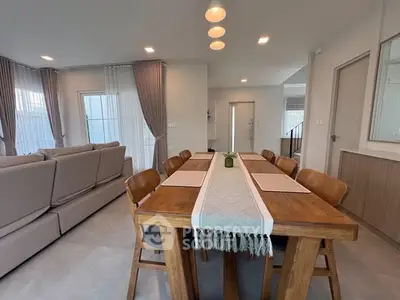 Spacious modern living room with elegant dining area and natural light