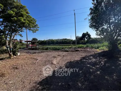 Spacious land plot with lush greenery and clear blue sky, perfect for development.