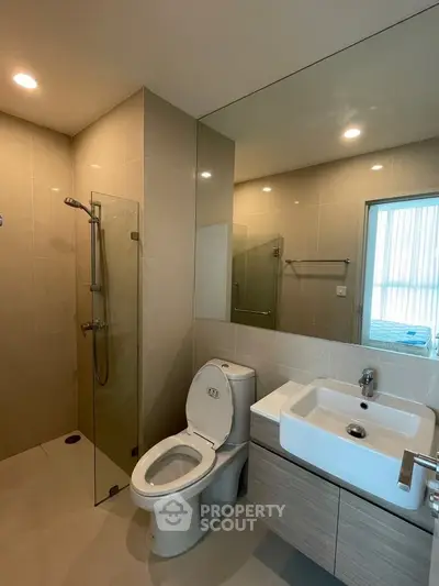 Modern bathroom with sleek fixtures and glass shower enclosure