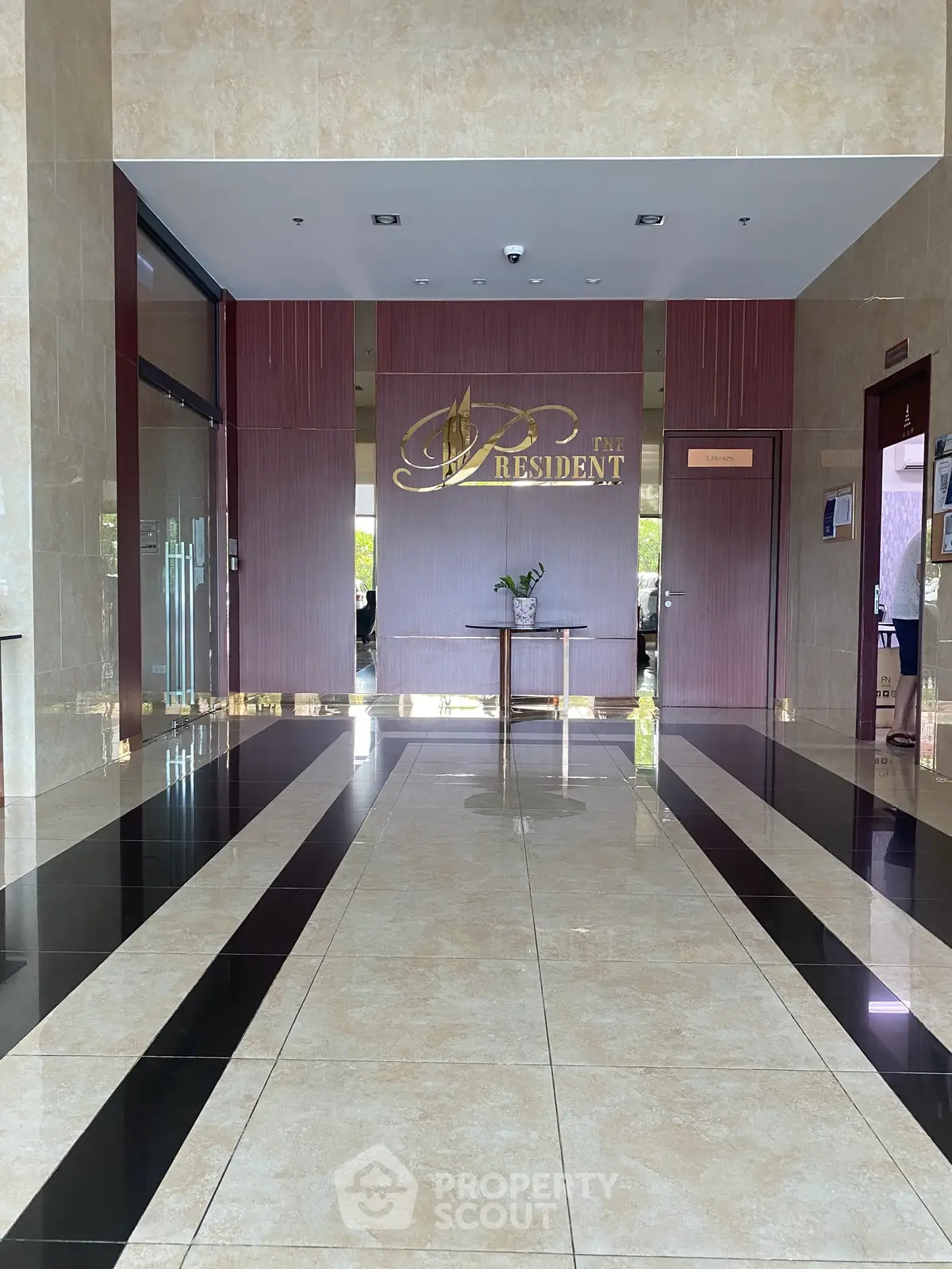 Luxurious building entrance with elegant marble flooring and modern design.