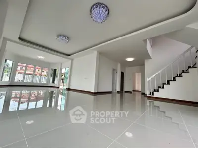 Spacious modern living room with glossy tile flooring and elegant lighting fixtures.