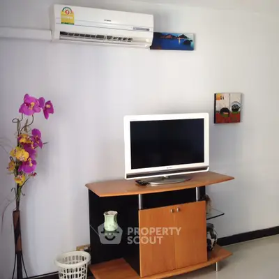 Modern living room with sleek TV stand and air conditioning unit