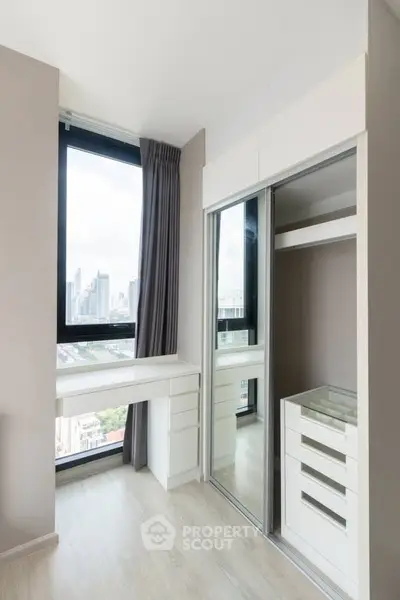 Modern bedroom with city view and built-in closet, perfect for urban living.