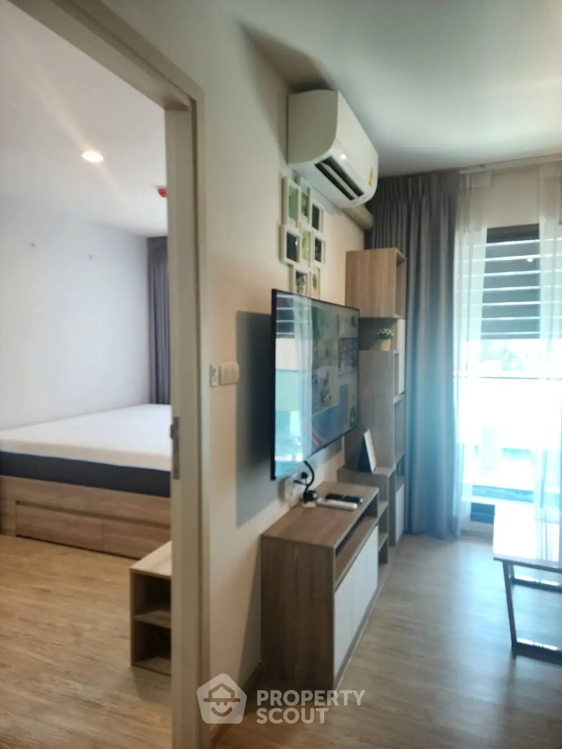 Modern apartment interior with stylish living room and bedroom, featuring sleek furniture and natural light.