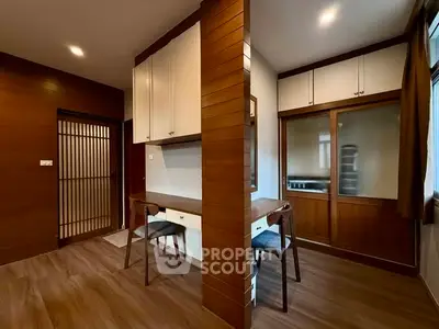 Modern study room with wooden accents and built-in desk in a cozy apartment.