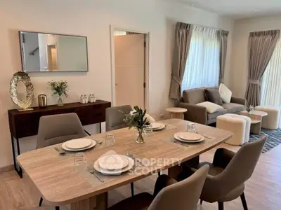 Elegant dining and living area with modern decor and natural light