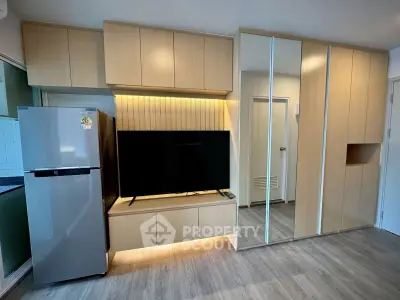 Modern living room with sleek built-in cabinets and large flat-screen TV