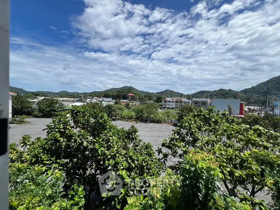 Scenic view of lush greenery and distant hills from a property, ideal for nature lovers.
