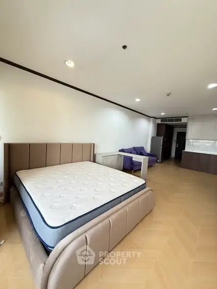 Spacious bedroom with modern furniture and open layout in a stylish apartment.