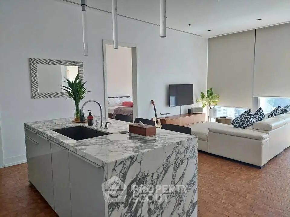 Modern open-layout kitchen and living room with marble island and stylish decor