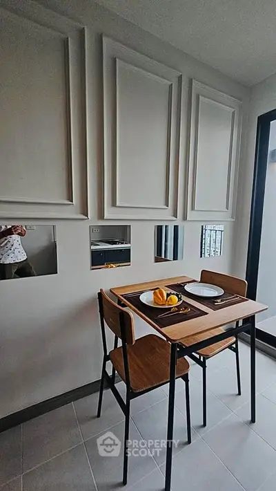 Modern dining area with stylish wall panels and compact table setting