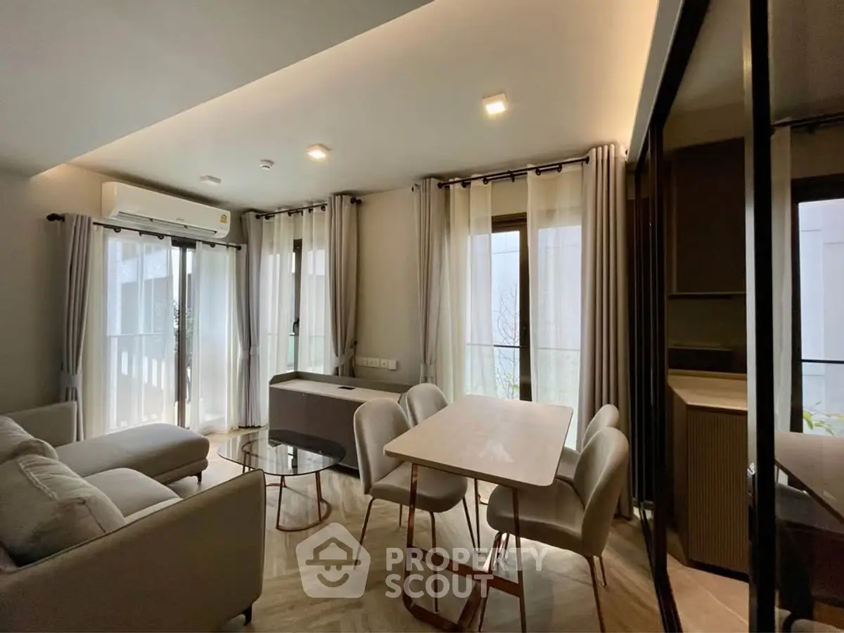 Modern living room with dining area and natural light