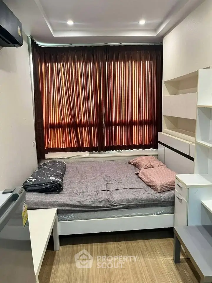 Cozy bedroom with modern furnishings and large window with curtains