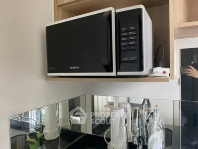 Modern kitchen with microwave and sleek black countertop