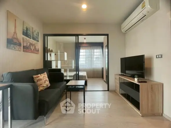Modern living room with sleek furniture and air conditioning in a stylish apartment.