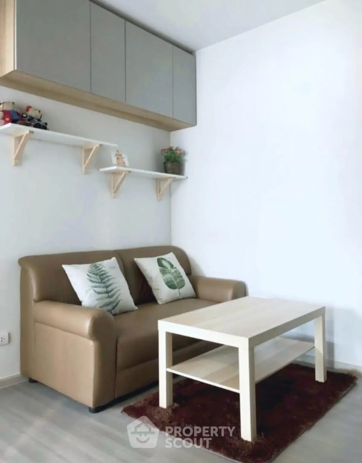 Cozy living room with modern sofa and stylish shelving, perfect for relaxation.