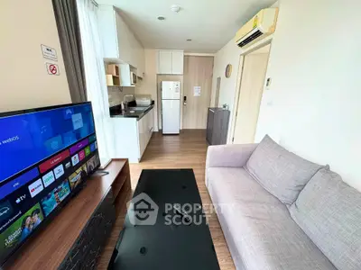Modern living room with sleek furniture and smart TV in a stylish apartment.
