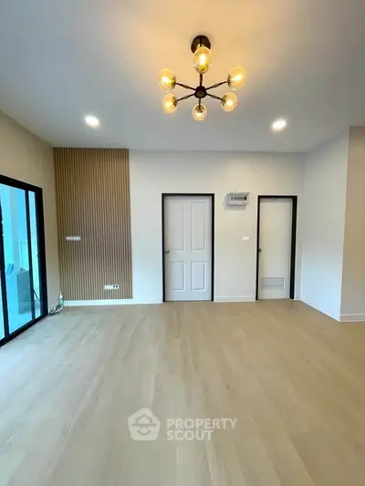 Spacious modern living room with elegant lighting and wooden flooring